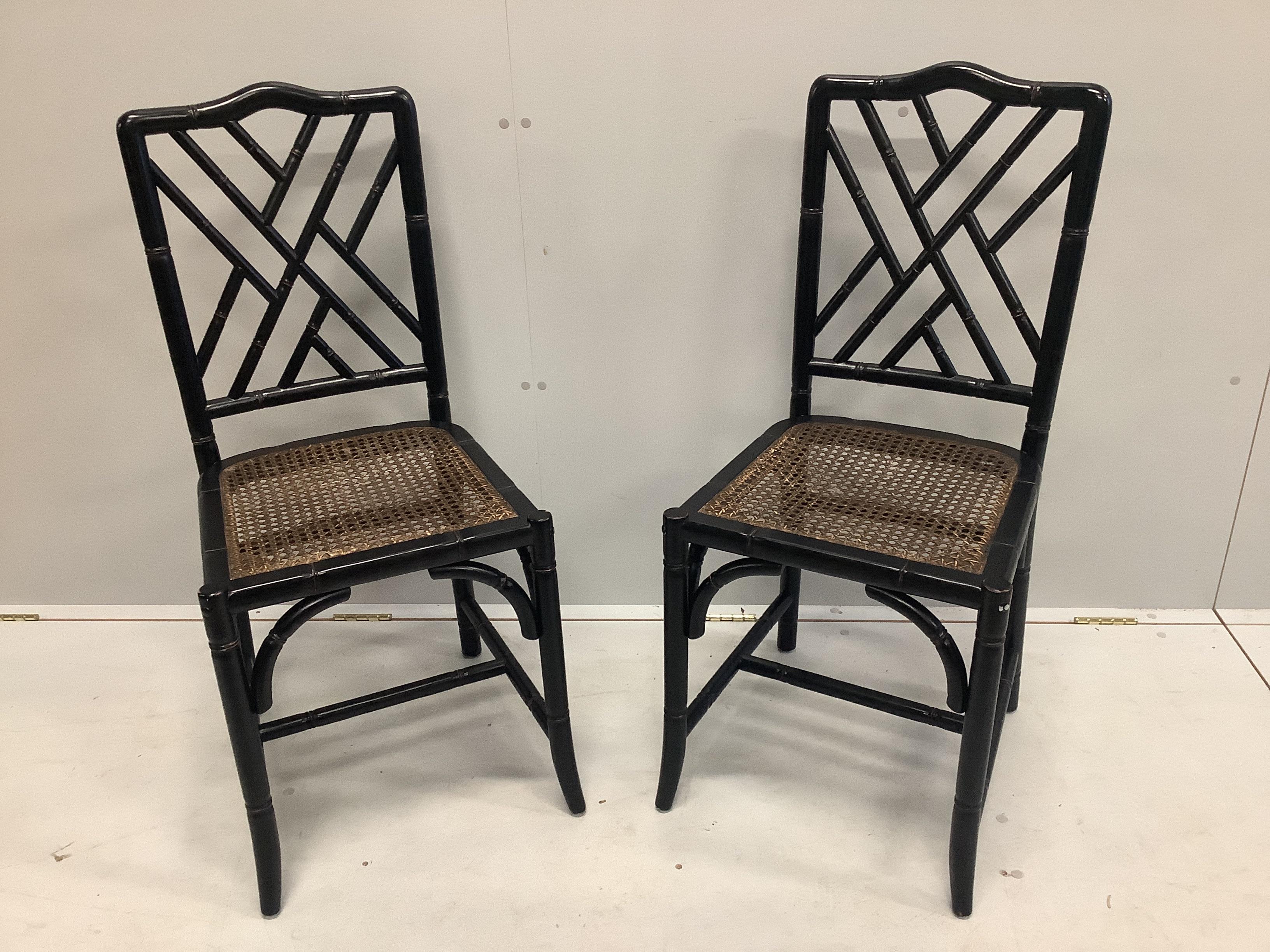 A pair of Oka style black lacquer faux bamboo cane seat dining chairs, width 43cm, depth 43cm, height 99cm